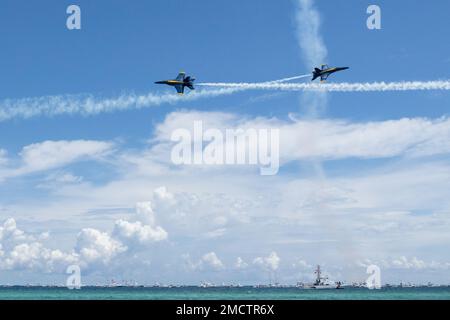 The Navy Flight Demonstration Squadron, the Blue Angels, perform various flight maneuvers in their hometown Pensacola, Florida, at the Pensacola Beach Air Show, July 9, 2022. The annual Blue Angels Airshow in Pensacola is a demonstration of patriotism and a welcome home to the squadron. Stock Photo