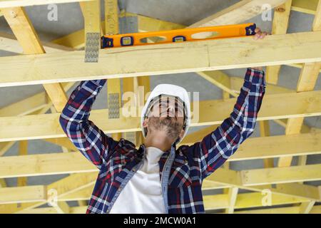 happy male construction worker adjusting ceiling Stock Photo