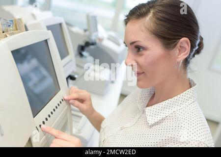 young attractive woman doctor touching icon of media screen Stock Photo