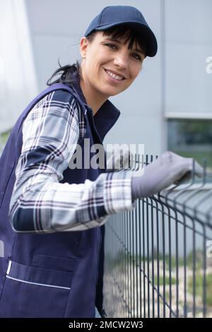 builder at construction site inspects a fence Stock Photo