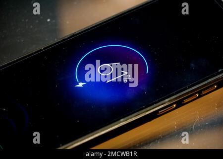 Close-up view of dirty smartphone charging Low battery level. Stock Photo