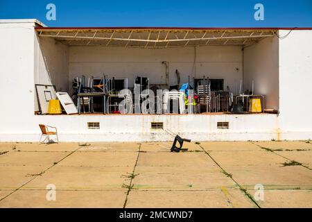 Pattern of messy chairs and tables in outdoor storage in Farol island, Algarve, Portugal Stock Photo