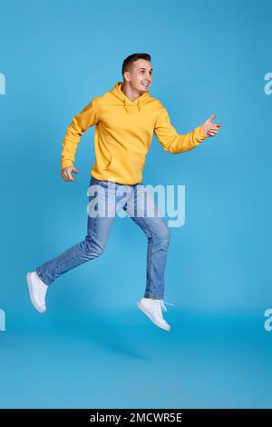 young happy man in casual clothes jumping Stock Photo