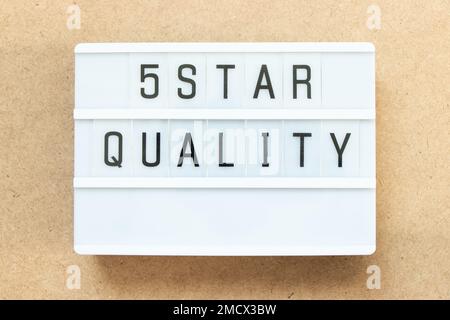 Lightbox with word 5 star quality on wood background Stock Photo