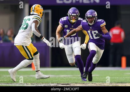 Minnesota Vikings wide receivers Justin Jefferson (18) and Adam Thielen  (19) celebrate after Jefferson scored a touchdown against the New York  Jets, during the second half of an NFL football game Sunday