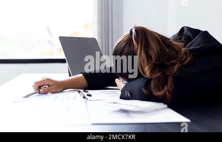Financial accountant works on analyzing and summarizing the company's incomes and expenses in real estate and account management, causing her to get t Stock Photo