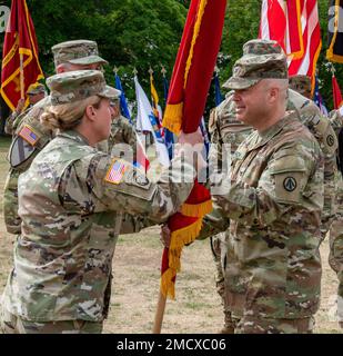 U.S. Army Col. Joshua D. Hirsch, (right) outgoing 598th Transportation Brigade, Surface Deployment and Distribution Command commander passes the unit colors to Maj. Gen. Heidi J. Hoyle, (left) commanding general of Military Surface Deployment and Distribution Command during a change of command ceremony, July 11, 2022, at Daenner Kaserne, Kaiserslautern, Germany. The 598th TBDE executes mission command for strategic seaport operations in support of both U.S. European Command and U.S. Africa Command. Stock Photo