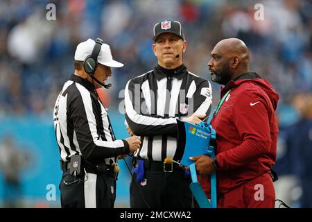 Referee Tony Corrente, left, watches a replay in the first half of