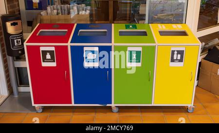 Aarhus, Denmark - November 16, 2022: Seperating waste in different colorful waste bins with Danish text for plastic packaging, food, paper and carton and residual waste Stock Photo