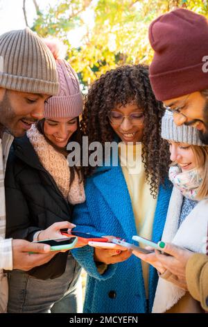 Vertical shot of group of people using smart phones. Millennials addicted to social media Stock Photo