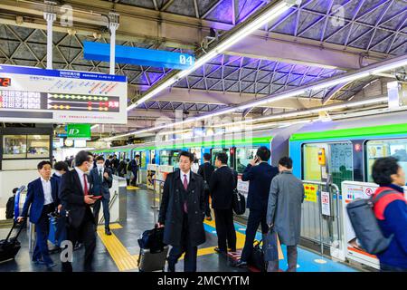 Tokyo Hamamatsucho station interior. Tokyo monorail train at the platform about to depart for Haneda International Airport. People queuing to board. Stock Photo