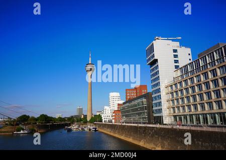 Medienhafen in Düsseldorf/Germany with Düsseldorf's landmark, the Rhine Tower, and modern Gehry Buildings by Frank O. Gehry. Stock Photo