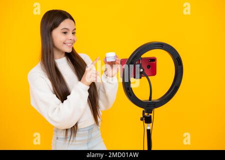 Teenager recording online media video. Teen girl streaming online and sharing social media content by mobile phone app network. Beauty blog Stock Photo