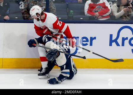 Detroit Red Wings forward Michael Rasmussen, left, passes the puck in front  of Columbus Blue Jackets forward Jack Roslovic during an NHL hockey game in  Columbus, Ohio, Saturday, May 8, 2021. (AP