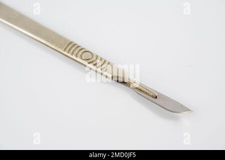 sterile stainless steel precision blade medical surgeons scalpel disposable   blade in metal handle isolated on a white background Stock Photo