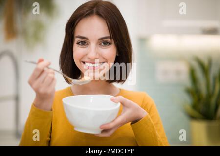 Portrait Of Pretty Smiling Fit Lady Having Oatmeal Stock Photo