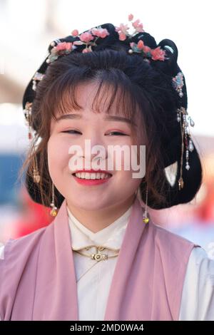 A woman of Chinese origin dressed in a traditional costume during the Chinese New Year parade celebration in Madrid. With more than 4,000 years of antiquity, it is the most important festivity of the Asian country and this year the protagonist will be the rabbit, an animal that represents peace, kindness and hope. China celebrates its New Year by following its own horoscope, which is governed by the phases of the moon, not the Gregorian calendar, so the yearly start date changes. The epicenter is the Usera district, which brings together the largest Chinese community in Madrid. Stock Photo