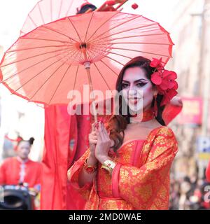 A woman of Chinese origin dressed in a traditional costume during the Chinese New Year parade celebration in Madrid. With more than 4,000 years of antiquity, it is the most important festivity of the Asian country and this year the protagonist will be the rabbit, an animal that represents peace, kindness and hope. China celebrates its New Year by following its own horoscope, which is governed by the phases of the moon, not the Gregorian calendar, so the yearly start date changes. The epicenter is the Usera district, which brings together the largest Chinese community in Madrid. Stock Photo