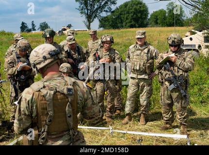 Maj. Gen. Jeffrey W. Jurasek, deputy commanding general of First Army (Support), second from right, listens to a briefing conducted by Staff Sgt. Miguel Galarza of the New Jersey’s Army National Guard’s Alpha Company, 1st Squadron, 102 Cavalry Regiment, 44th Infantry Brigade Combat Team at Fort Drum, N.Y. on July 12, 2022 as part of the unit’s training in the eXportable Combat Training Capability (XCTC) exercise. More than 2,500 Soldiers are participating in the training event, which enables brigade combat teams to achieve the trained platoon readiness necessary to deploy, fight, and win.