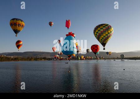 Hot-air balloons fly above the Papalote dam during the International Hot Air Balloon Festival in Leon, Mexico, Friday, Nov. 12, 2021. (AP Photo/Mario Armas)