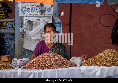 Local Indian Woman selling Nuts on a Stall in Panjim City (Panaji), Goa, India, Asia Stock Photo