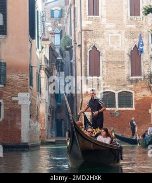 October 31, 2022 - Venice, Italy: Tourists taking a gondola ride in Venice. Tourism concept. Stock Photo