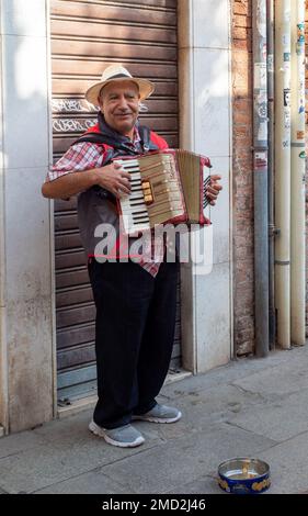 October 31, 2022 - Venice, Italy: Man playing the harmonica in the streets. Music concept. Stock Photo