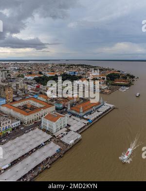 An aerial shot of the coastal city with ships on the sea against a clouded sky Stock Photo