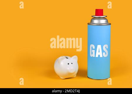 Gas cartridge bottle with piggy bank on yellow background. Concept for saving gas Stock Photo