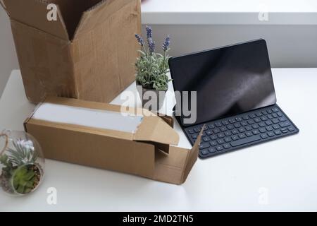 Shopping online e-comerce, Parcel boxes on a laptop. Stock Photo