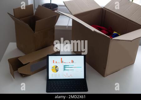 Shopping online e-comerce, Parcel boxes on a laptop. Stock Photo