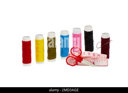 Image of seven spools of colored thread small scissors and centimeter Stock Photo