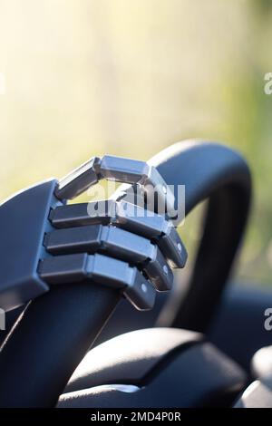 Robot arm on a steering wheel. Artificial intelligence drives a car. Autonomous vehicle concept. Stock Photo