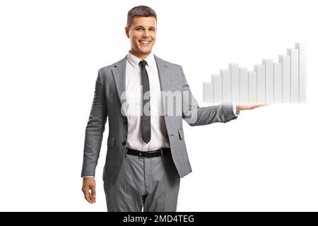 Young man in suit and tie smiling and holding a bar chart isolated on white background Stock Photo