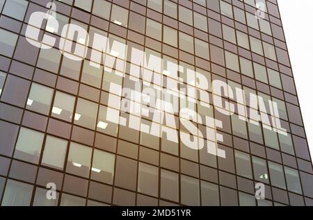 Business concept. On the glass surface of the business center there is an inscription - COMMERCIAL LEASE Stock Photo