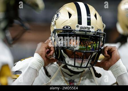 The reflection of New Orleans Saints running back Alvin Kamara (41) is seen  in his visor as he runs through drills at the team's NFL football minicamp  in Metairie, La., Thursday, June