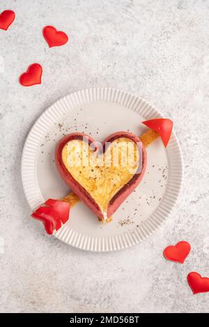 Heart shaped sausage and scrambled eggs for a romantic breakfast