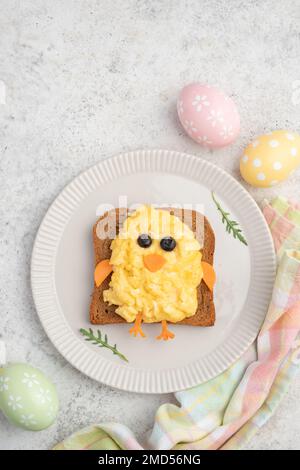 Funny toast with scrambled eggs in a shape of chicken Stock Photo
