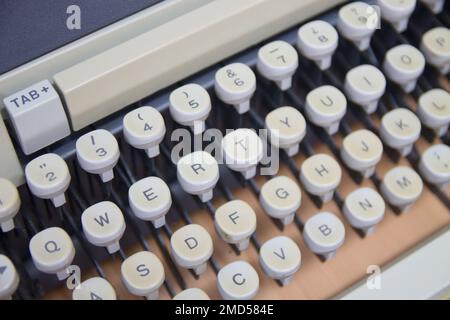 Closeup of the keyboard of an old mechanical typewriter with white keys and qwerty keyboard layout Stock Photo
