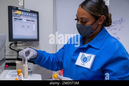 U.S. Air Force Staff Sgt. Kahrinna Cutts, 56th Medical Group medical laboratory technician, loads samples into the ACCESS 2 immunoassay chemistry system, July 13, 2022, at Luke Air Force Base, Arizona. The 56th MDG provides medical care for military members and their families to mitigate health concerns and enhance Airmen’s ability to focus on mission readiness. 56th Medical Group,AIR FORCE,Luke Air Force Base, Stock Photo