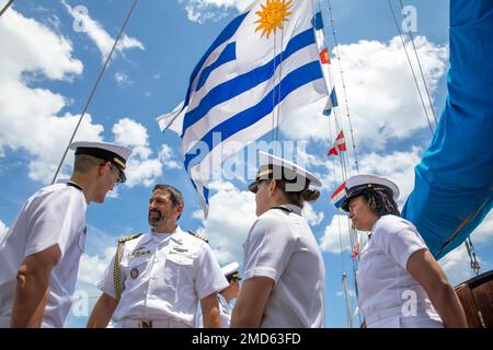 220713-N-GF955-1129  NAVAL STATION MAYPORT, Fla. (July, 13, 2022) Uruguayan navy Capt. Diego Grolero, Naval Attaché, Embassy of Uruguay, speaks with Cmdr. Nicholas Gurley, commanding officer of the Arleigh Burke-class guided-missile destroyer USS Farragut (DDG 99), left, Ensign Kyndal Olander, assigned to the Farragut, and Chief Yeoman Risha Ellis, assigned to U.S. Naval Forces Southern Command/U.S. 4th Fleet, right, during a tour of the Uruguay navy tall ship, Capitán Miranda at Naval Station Mayport, Fla., July 13, 2022. Capitán Miranda is conducting its XXXII Training Trip and is visiting N Stock Photo