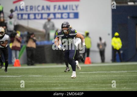 Seattle Seahawks linebacker Jon Rhattigan (59) runs with the 12 flag before  an NFL football game against the Tennessee Titans, Sunday, Sept. 19, 2021,  in Seattle. (AP Photo/Elaine Thompson Stock Photo - Alamy