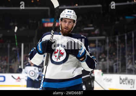 Winnipeg Jets center Pierre-Luc Dubois, top, puts Vancouver Canucks  defenseman Quinn Hughes (43) into the boards during second-period NHL  hockey game action in Vancouver, British Columbia, Sunday, Feb. 21, 2021.  (Jonathan Hayward/The