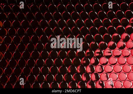 Abstract modern futuristic trendy silver circles pattern background texture reflecting red light Stock Photo