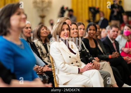 Reportage: House Speaker Nancy Pelosi listens as President Joe Biden delivers remarks at a Women’s History Month event, Tuesday, March 15, 2022, in the East Room of the White House Stock Photo