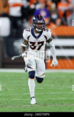 Nine-month-old James Locke IV, right, is held by his father, Denver Broncos  defensive back P.J. Locke (37) after taking part in drills at an NFL  football training camp at team headquarters Saturday