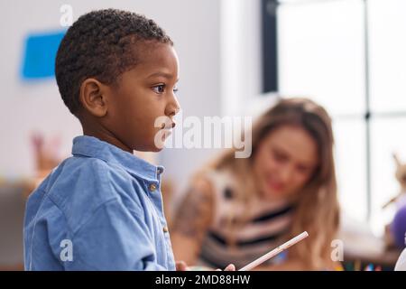 Teacher and toddler playing at kindergarten Stock Photo