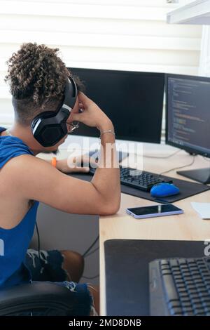 Tired man working at home, concentrating on the computer screen. Stock Photo