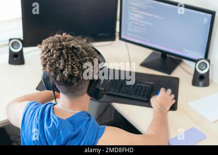 Male programmer working at his desk at home Stock Photo