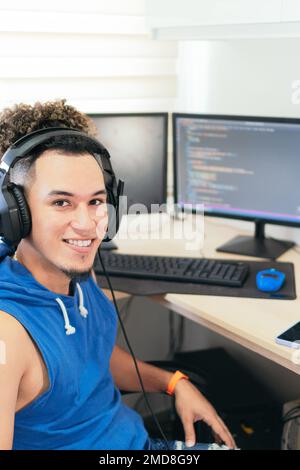 Portrait of a computer programmer working at home, looking at the camera smiling. Stock Photo